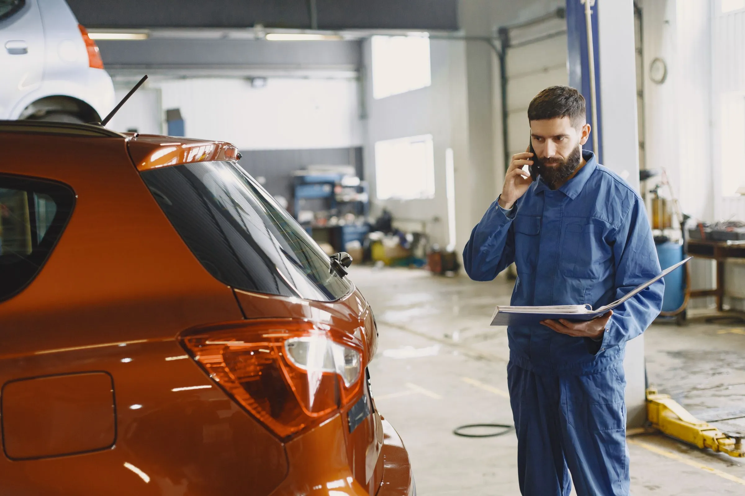 Mechanic taking a phone call in his auto shop