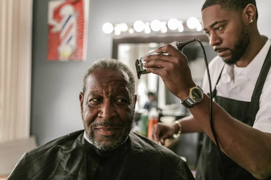 Barber giving a customer a haircut