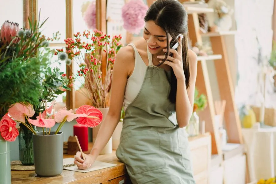 Florist taking a phone call in her shop