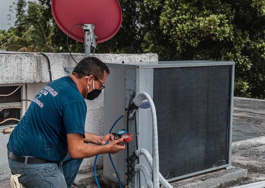 Technician working on an outdoor AC unit